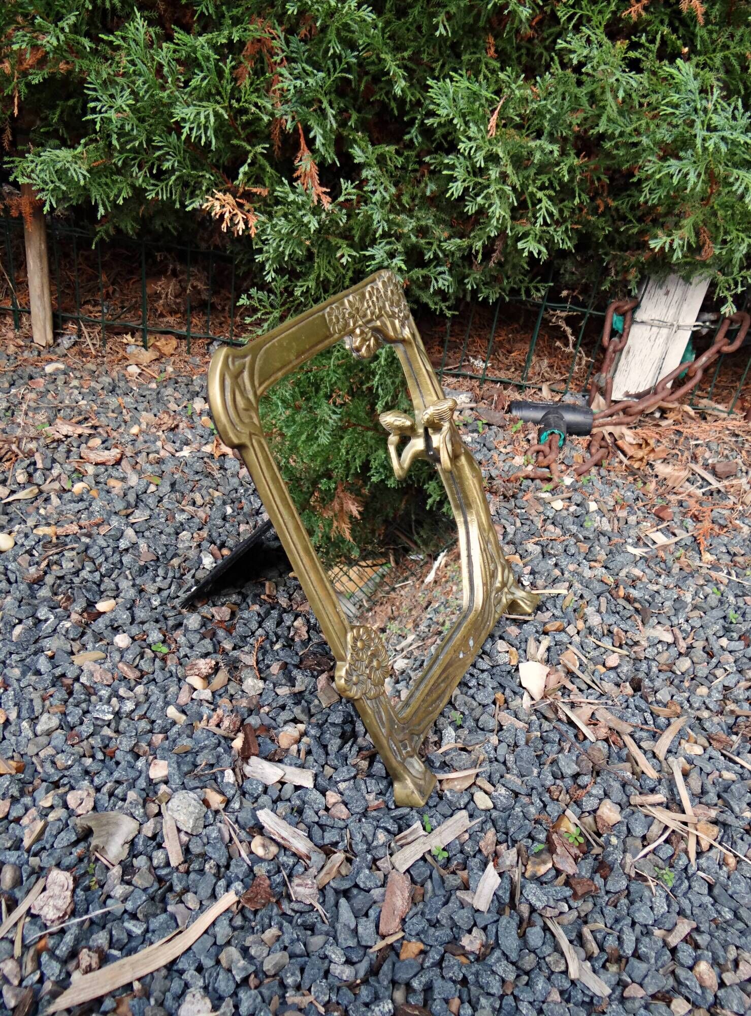 Art Nouveau mirror in gilded brass with a woman figure emerging from a vintage frame