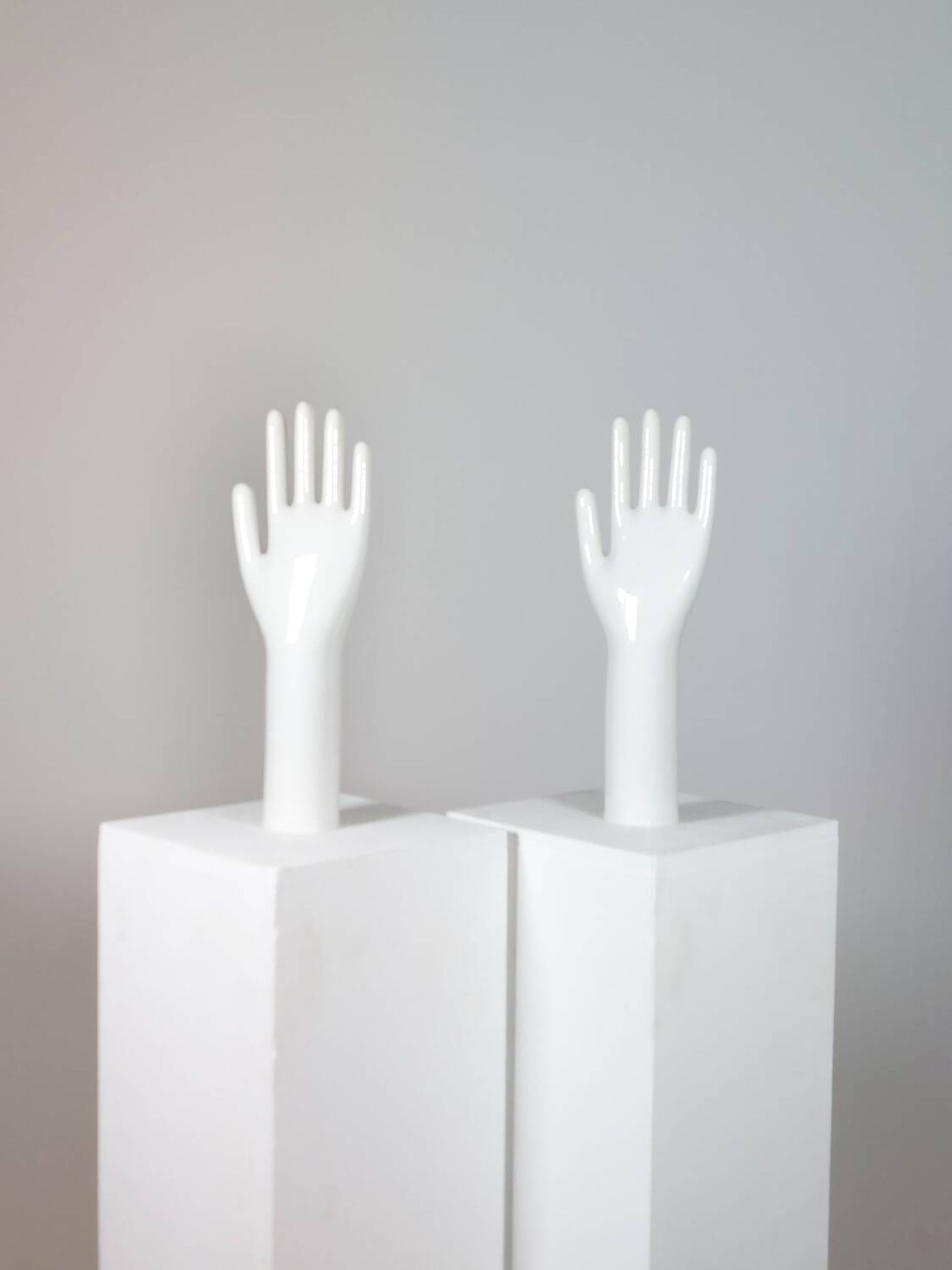 Pair of authentic vintage jewellery displays in industrial porcelain representing hands.