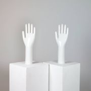 Pair of authentic vintage jewellery displays in industrial porcelain representing hands.