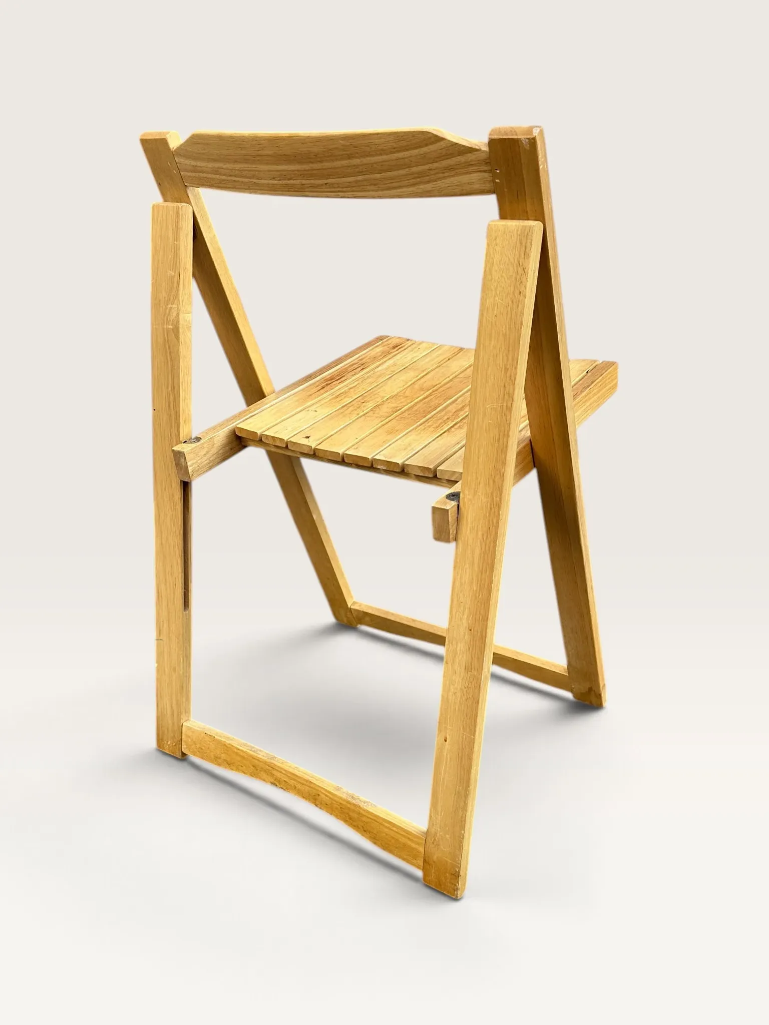 Blonde wooden folding chair in the style of Aldo Jacober.