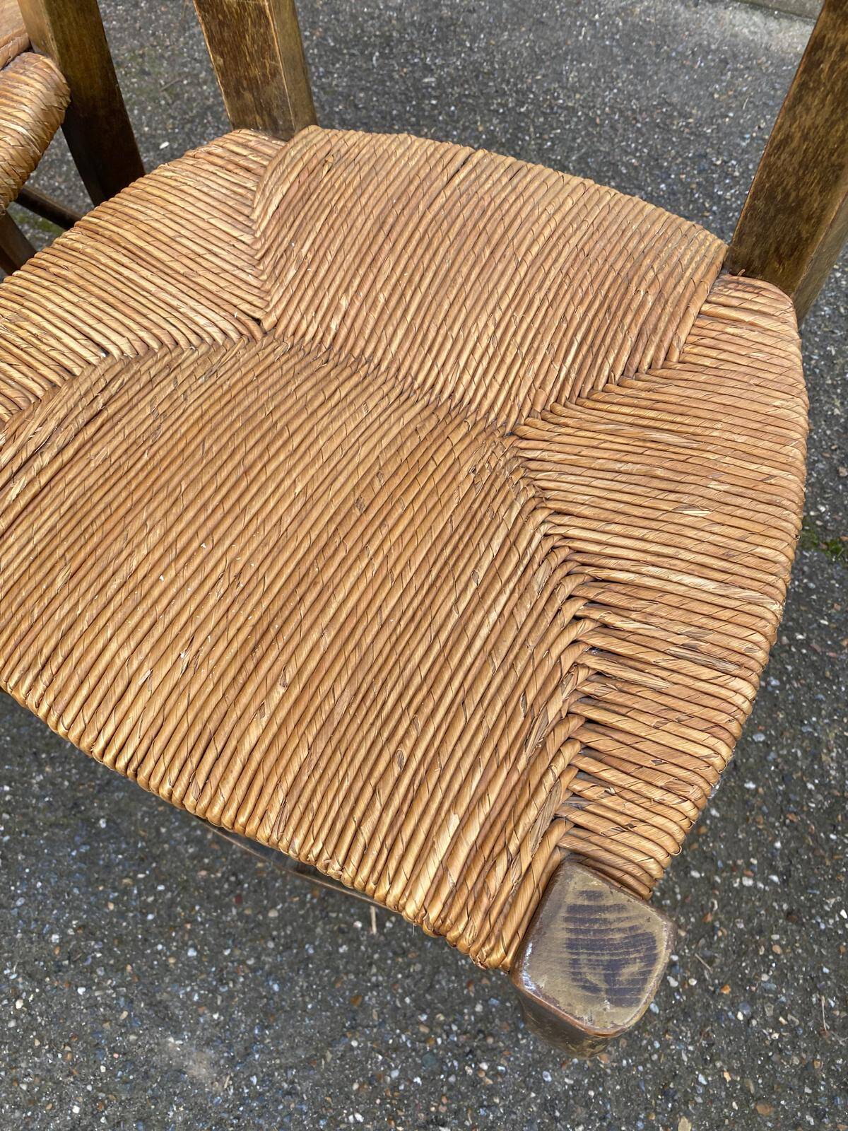 2 solid oak carved and rush-seated chairs in the Louis XV style from the 19th century.