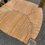 2 solid oak carved and rush-seated chairs in the Louis XV style from the 19th century.