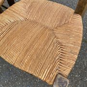 2 solid oak carved and rush-seated chairs in the Louis XV style from the 19th century.