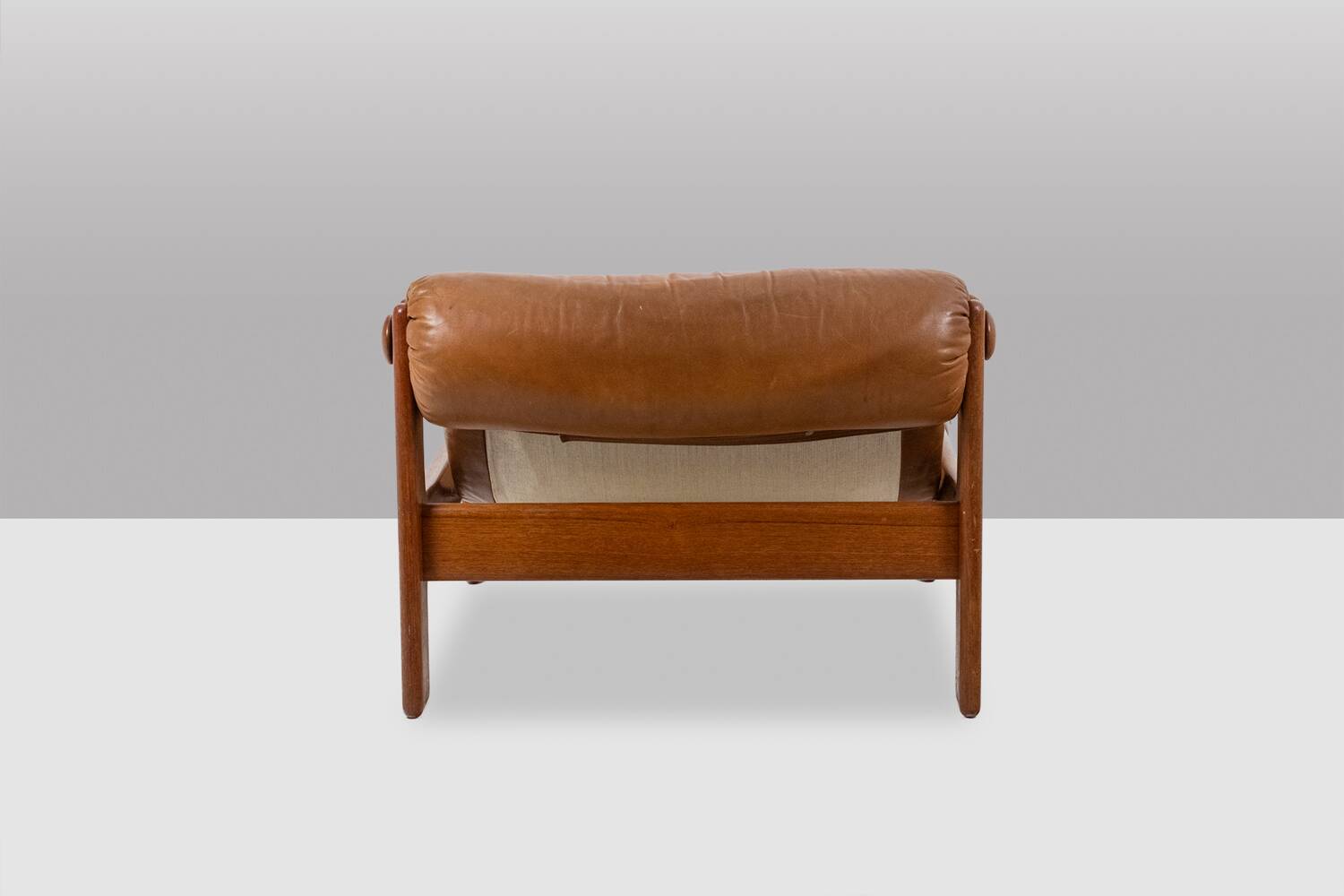 Lounge chair and ottoman, in blond elm and leather. 1970s