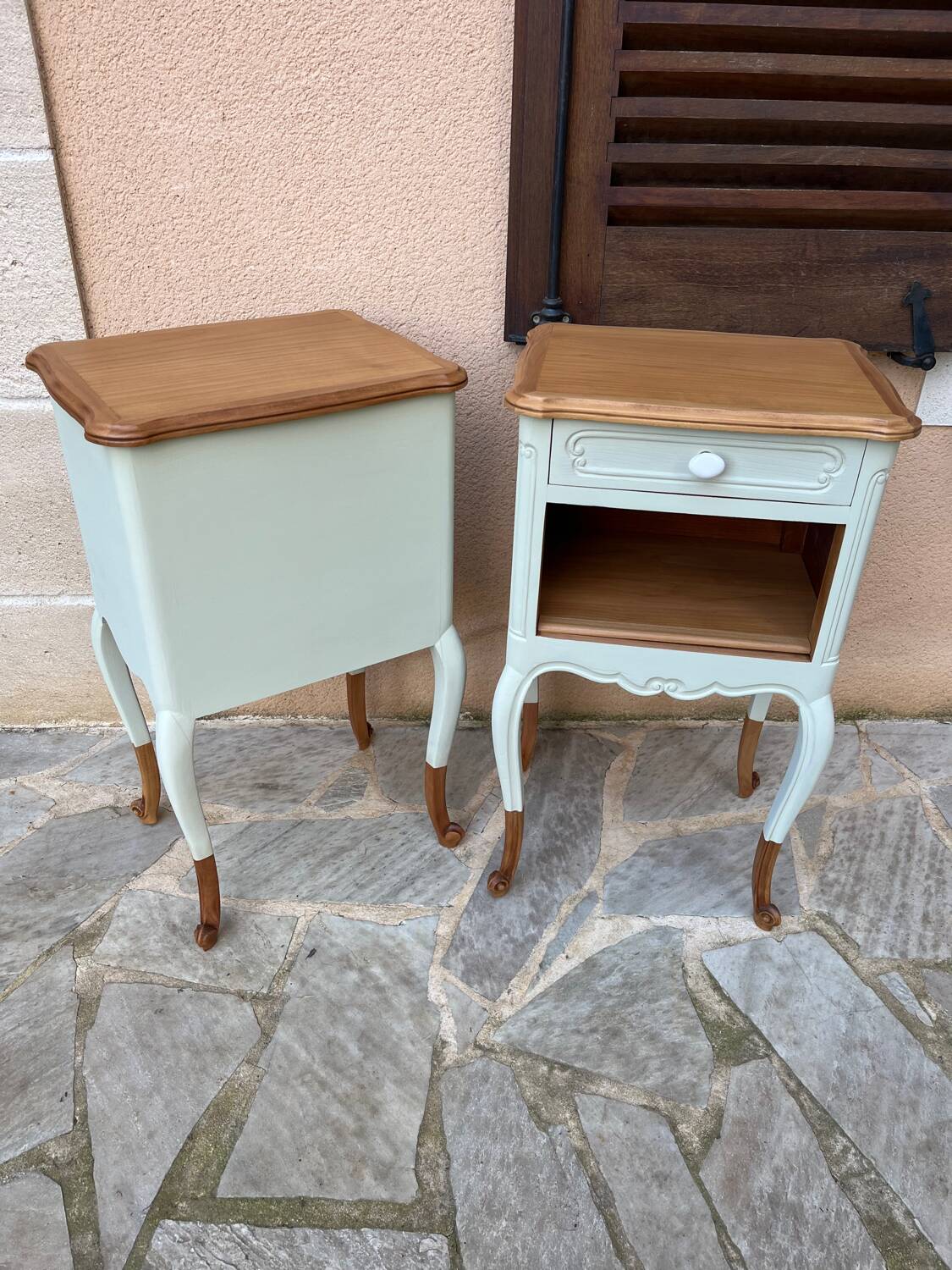 Renovated bedside tables in laurel green and light wood.