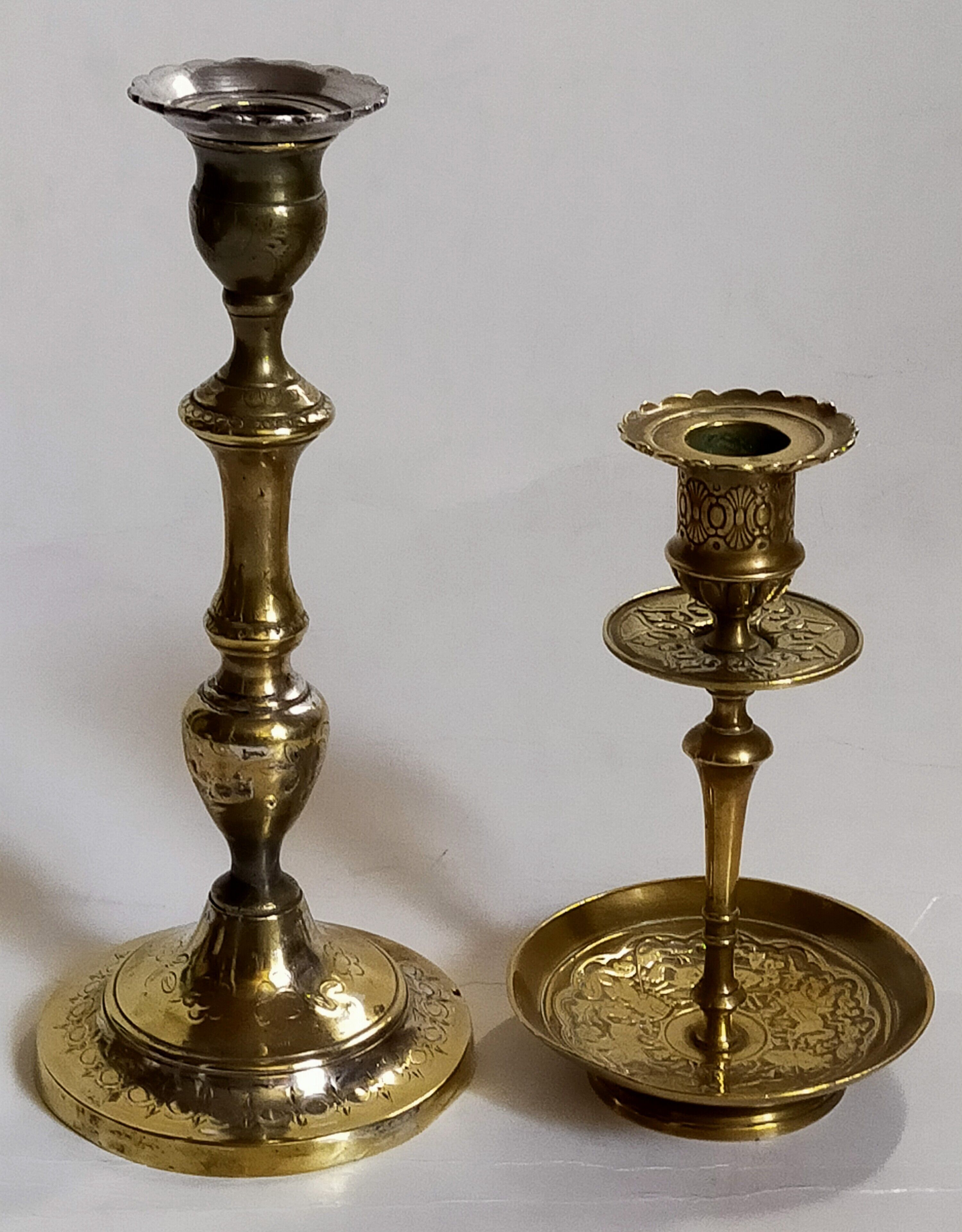 Duo of solid brass and gold metal candle holders worked old