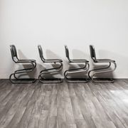 Ensemble de 4 chaises à bascule en acier chromé design années 80 vintage moderne.