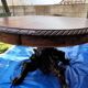 Round table in molded and carved oak with quill decoration, central shaft with 4 runners