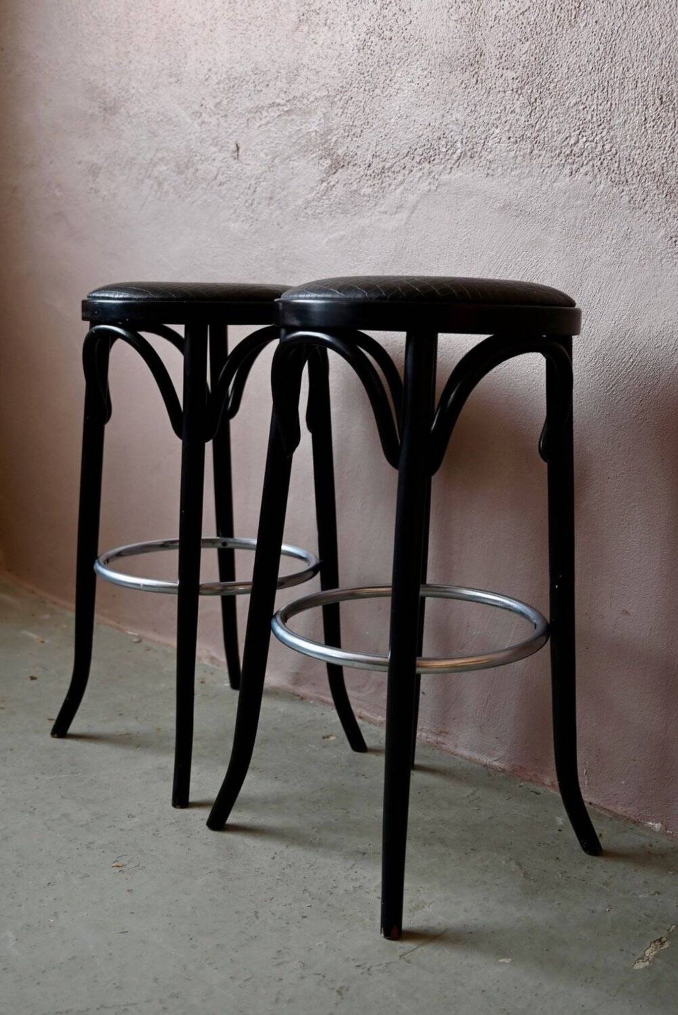 Pair of 1960s bistro bar stools in black and chrome with vinyl shell.