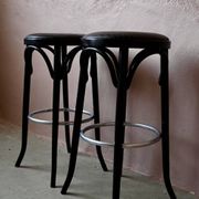 Pair of 1960s bistro bar stools in black and chrome with vinyl shell.