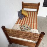 Brutalist style bed with chain and straw