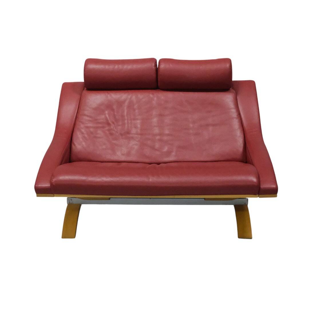 Two-seater red leather sofa by Roche Bobois on a bent beech base, France.