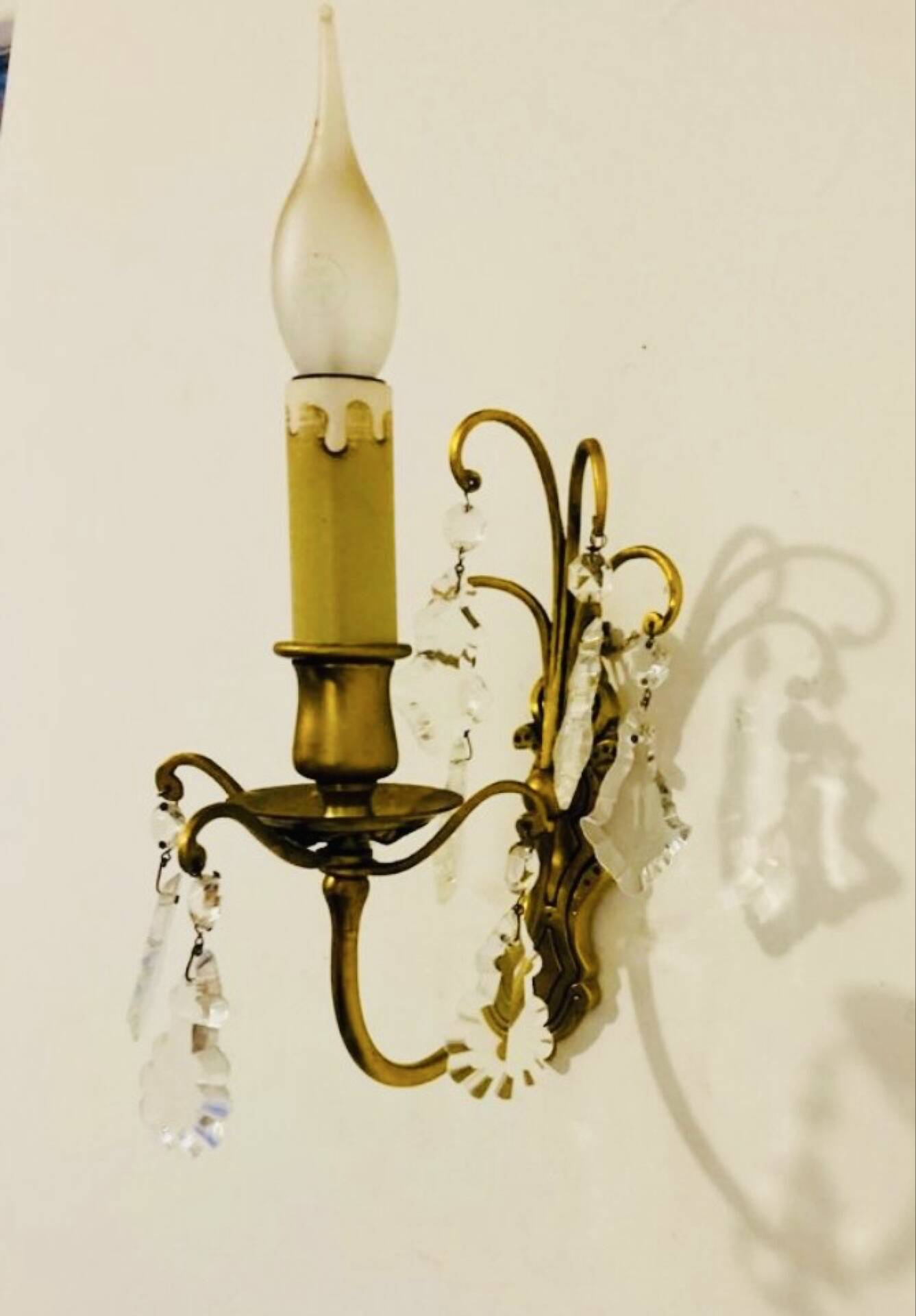 Brass wall light with glass pendants from the mid-20th century.