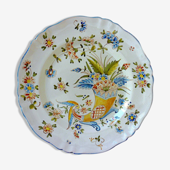 A plate of earthenware decorated with a cornucopia in St. Clement's earthenware