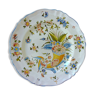 A plate of earthenware decorated with a cornucopia in St. Clement's earthenware