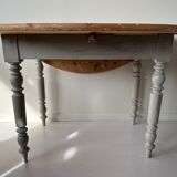 Round wooden table with flaps
