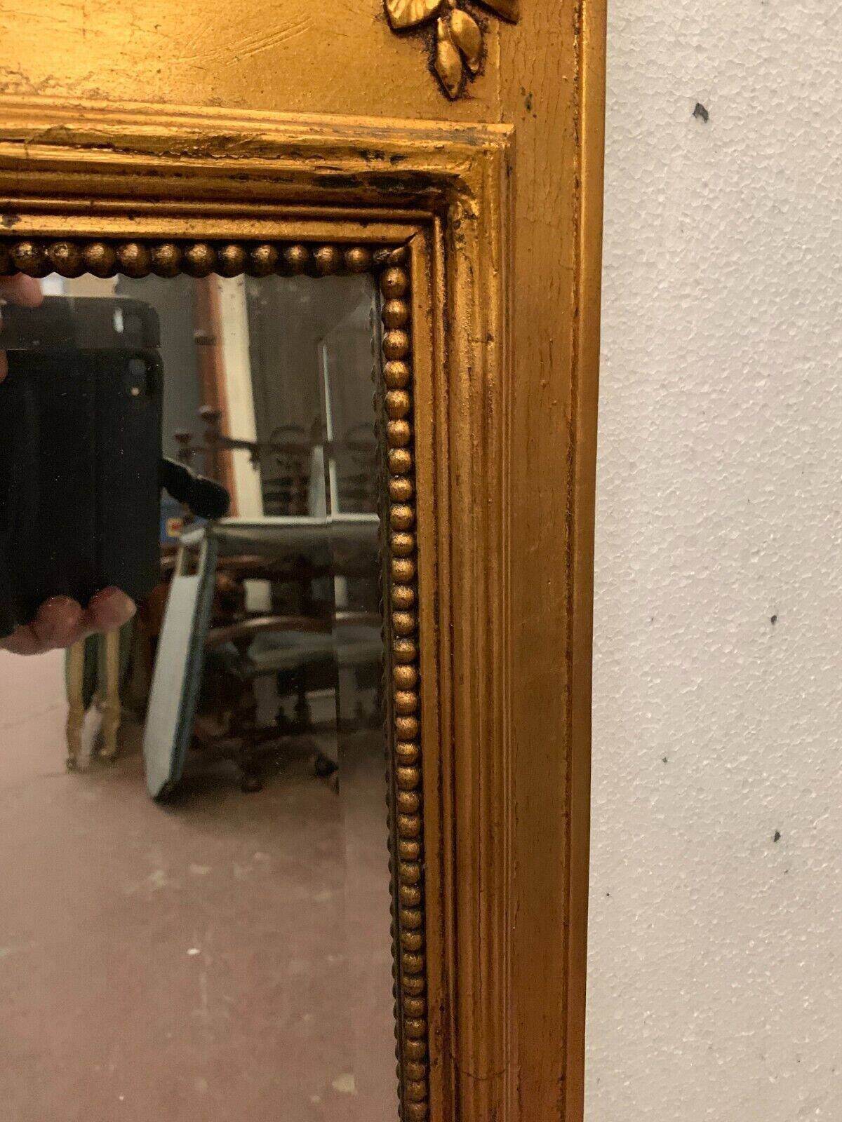 Louis XVI style mirror in wood and gilded stucco 20th century