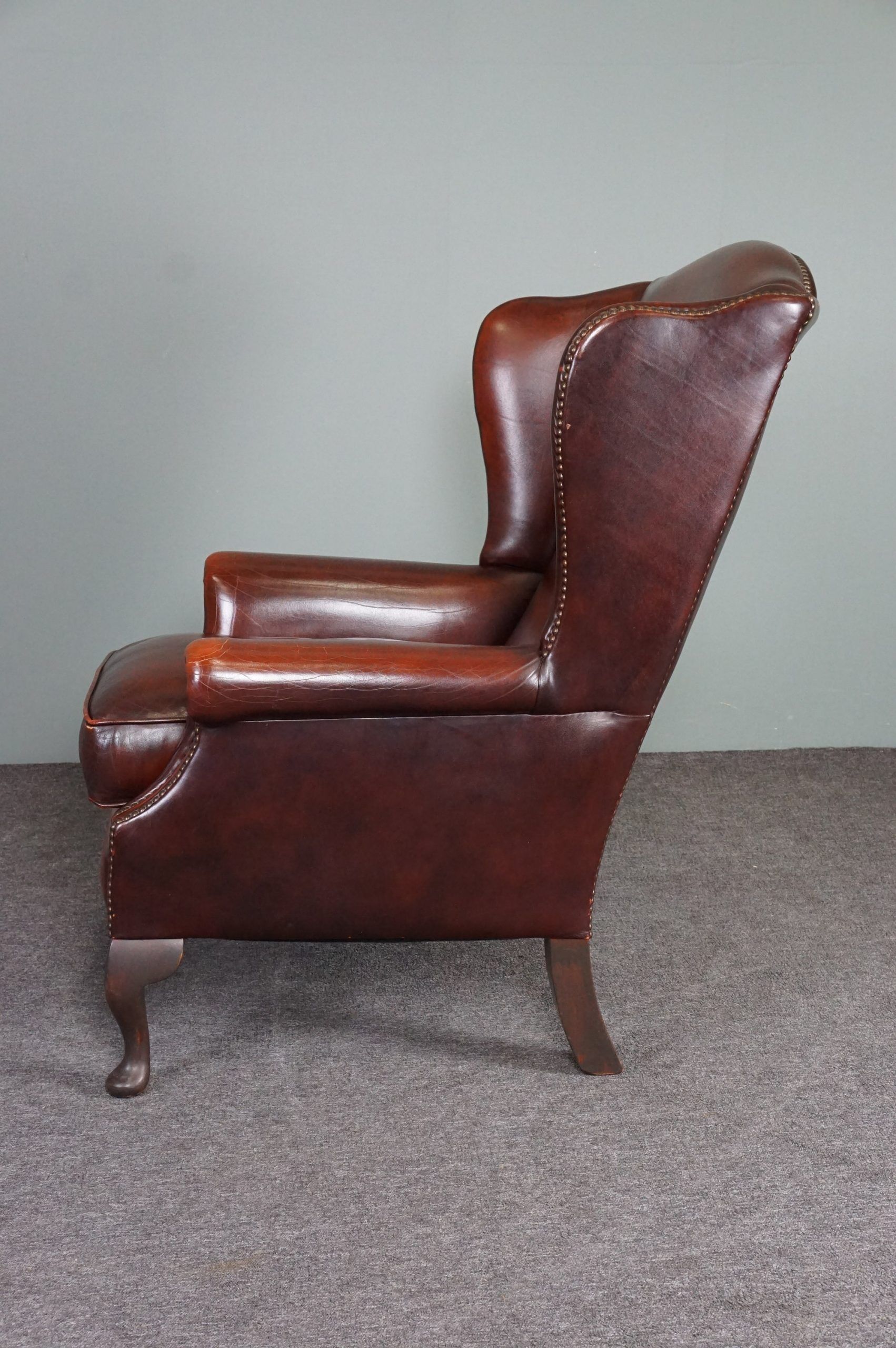 Leather armchair with decorative nails