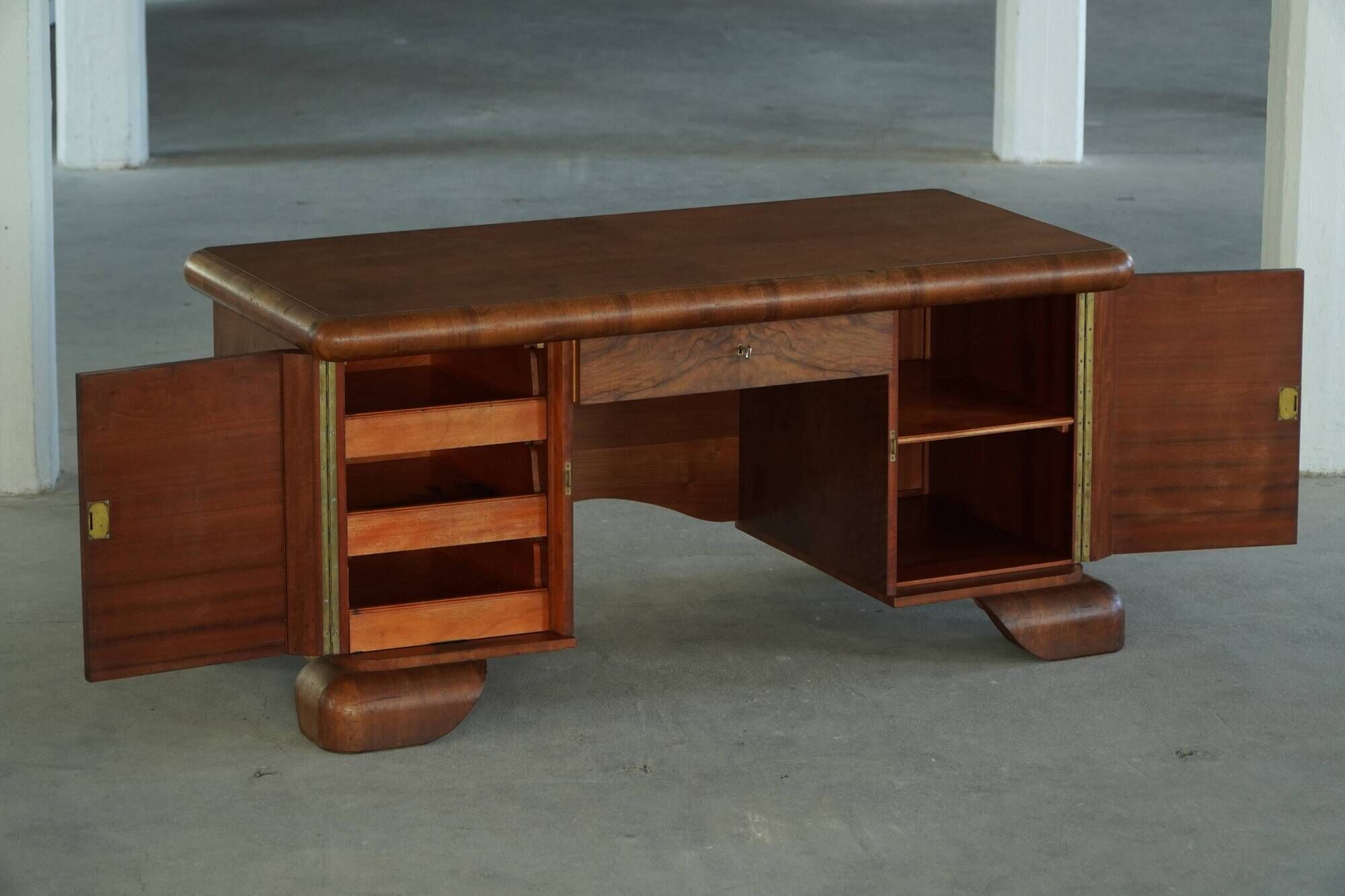 Art Deco desk, sculptural and expressive, in walnut, made by a French cabinetmaker, 1930s.