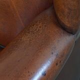 Sheepskin Wingback Chair with Warm Tones and Black Piping