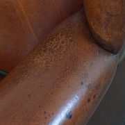 Sheepskin Wingback Chair with Warm Tones and Black Piping
