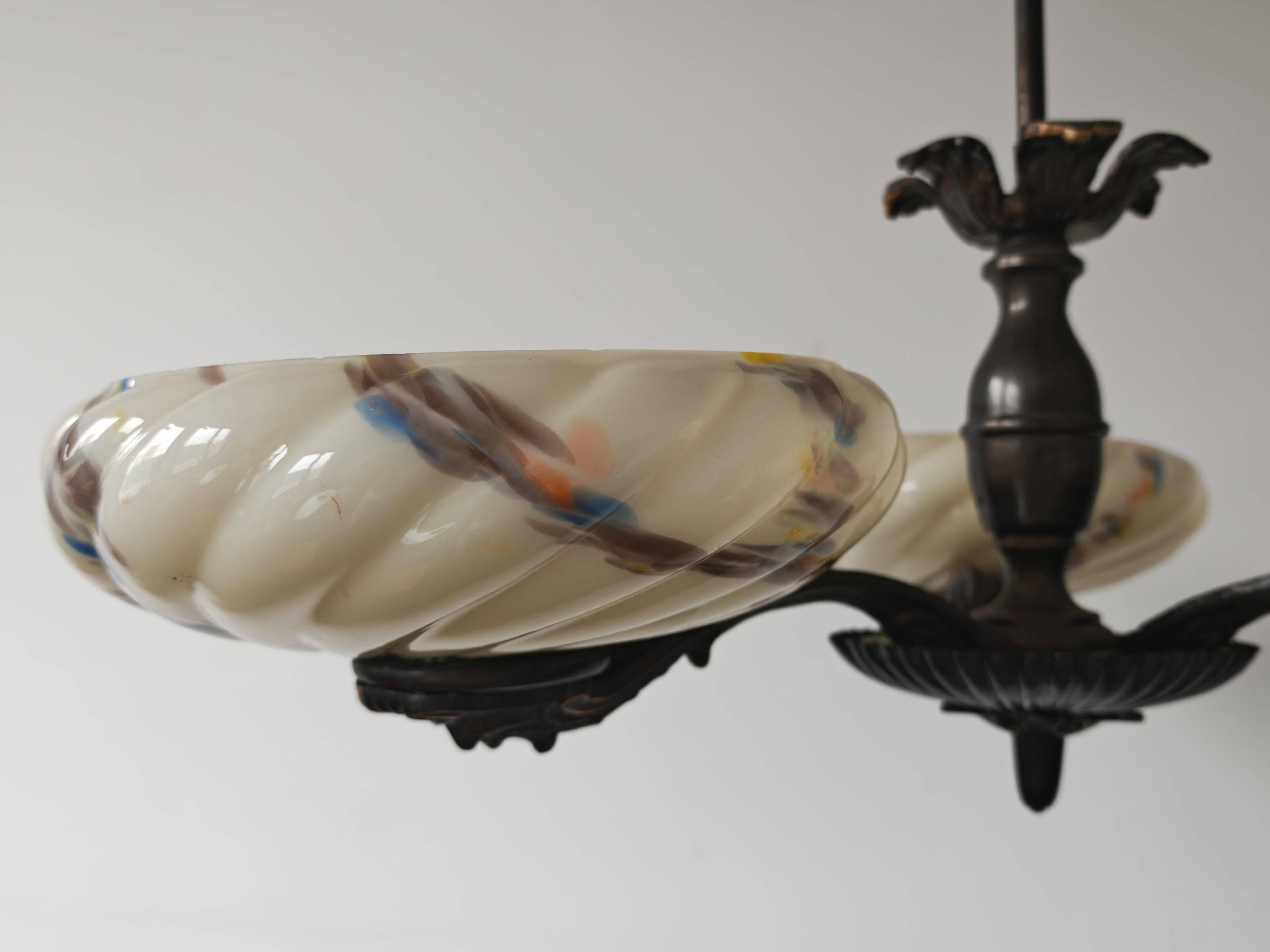Art Deco bronze three-arm chandelier with marbled glass shades.