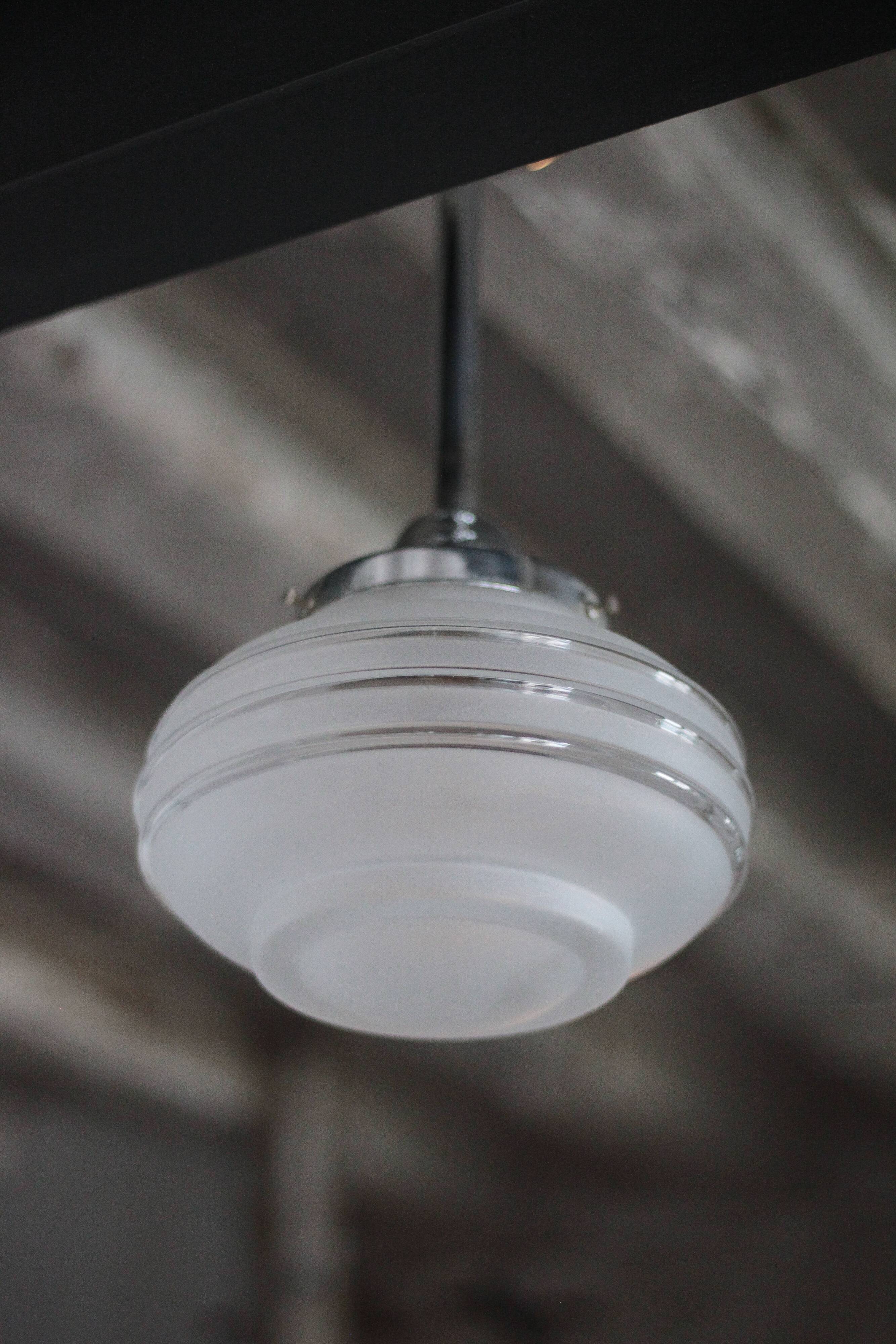 Art Deco pendant light, chrome metal suspension and glass globe, ceiling lamp.