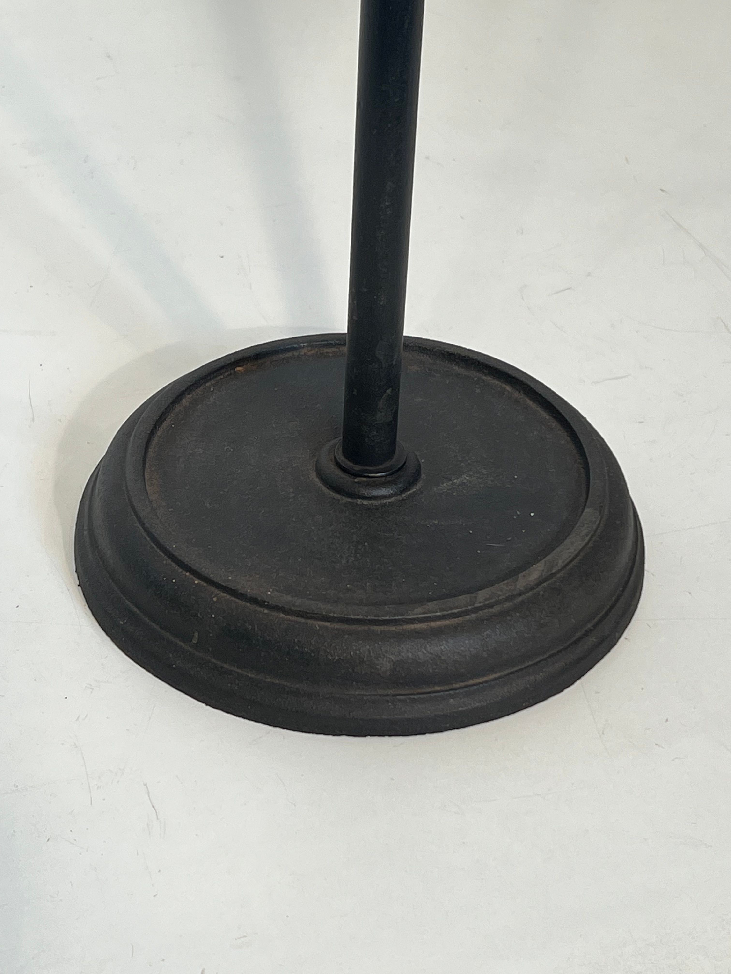 Neoclassical-style fire accessory in black lacquered metal and brass with fleur-de-lis.