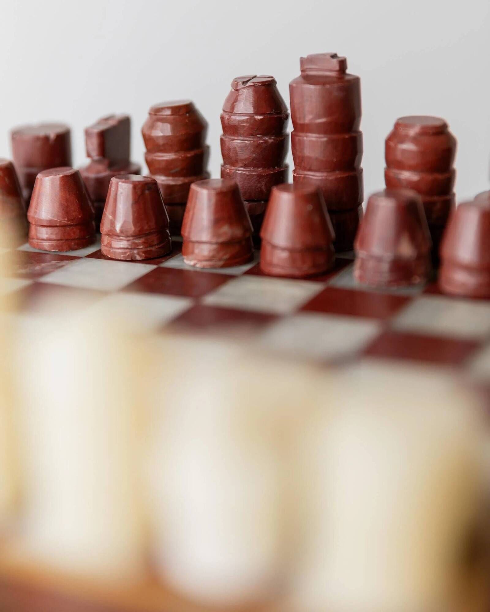 Vintage marble chess set from the 1960s, cream, burgundy and gold board with metal inlay, stone pieces.