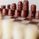 Vintage marble chess set from the 1960s, cream, burgundy and gold board with metal inlay, stone pieces.