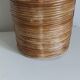 Rattan and brass pot cover