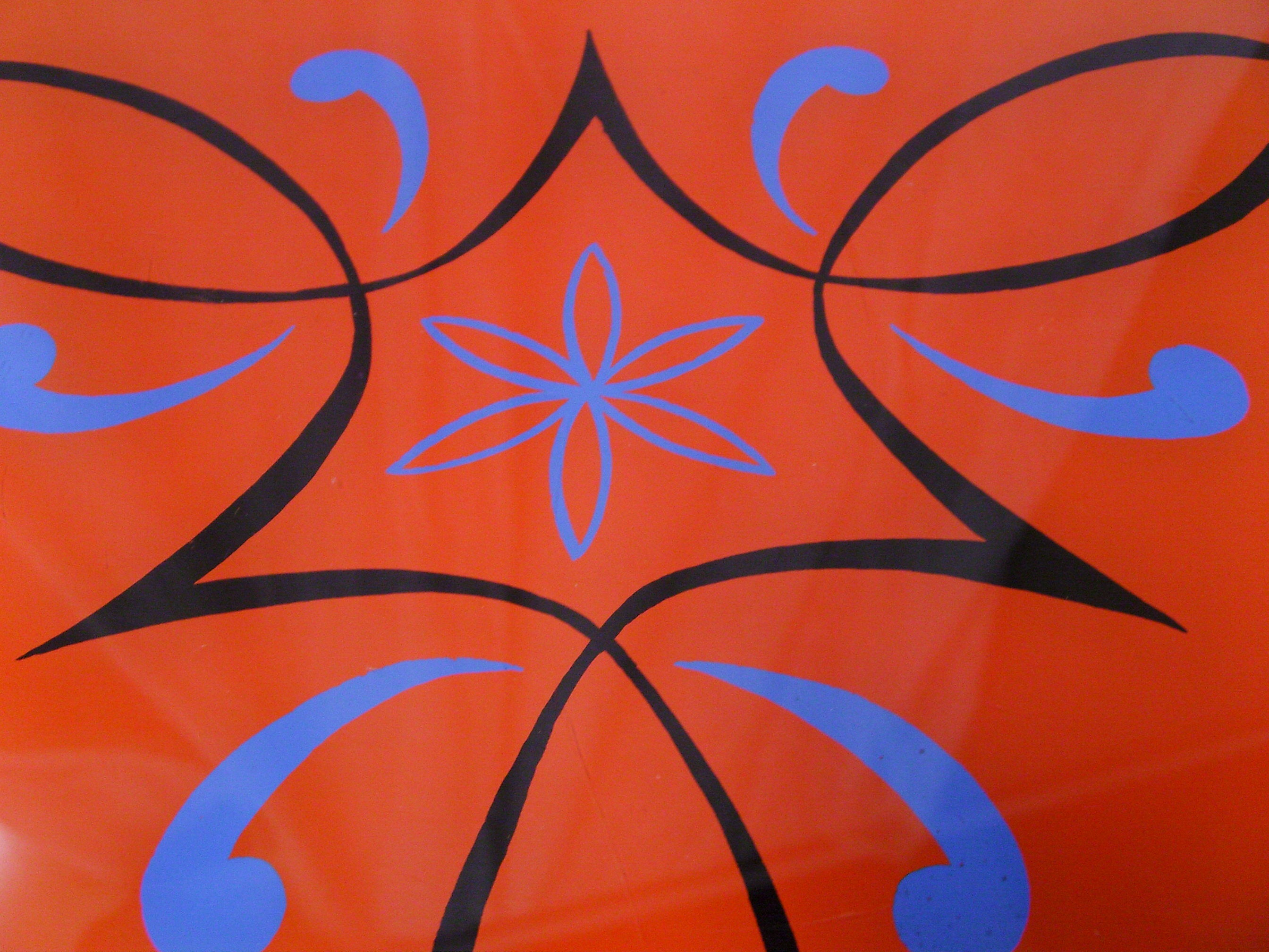 Plant holder tripod in geometrically patterned orange formica