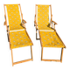 2 vintage Chilean deck chairs made of wood and yellow fabric printed with sailboats, with footrests.