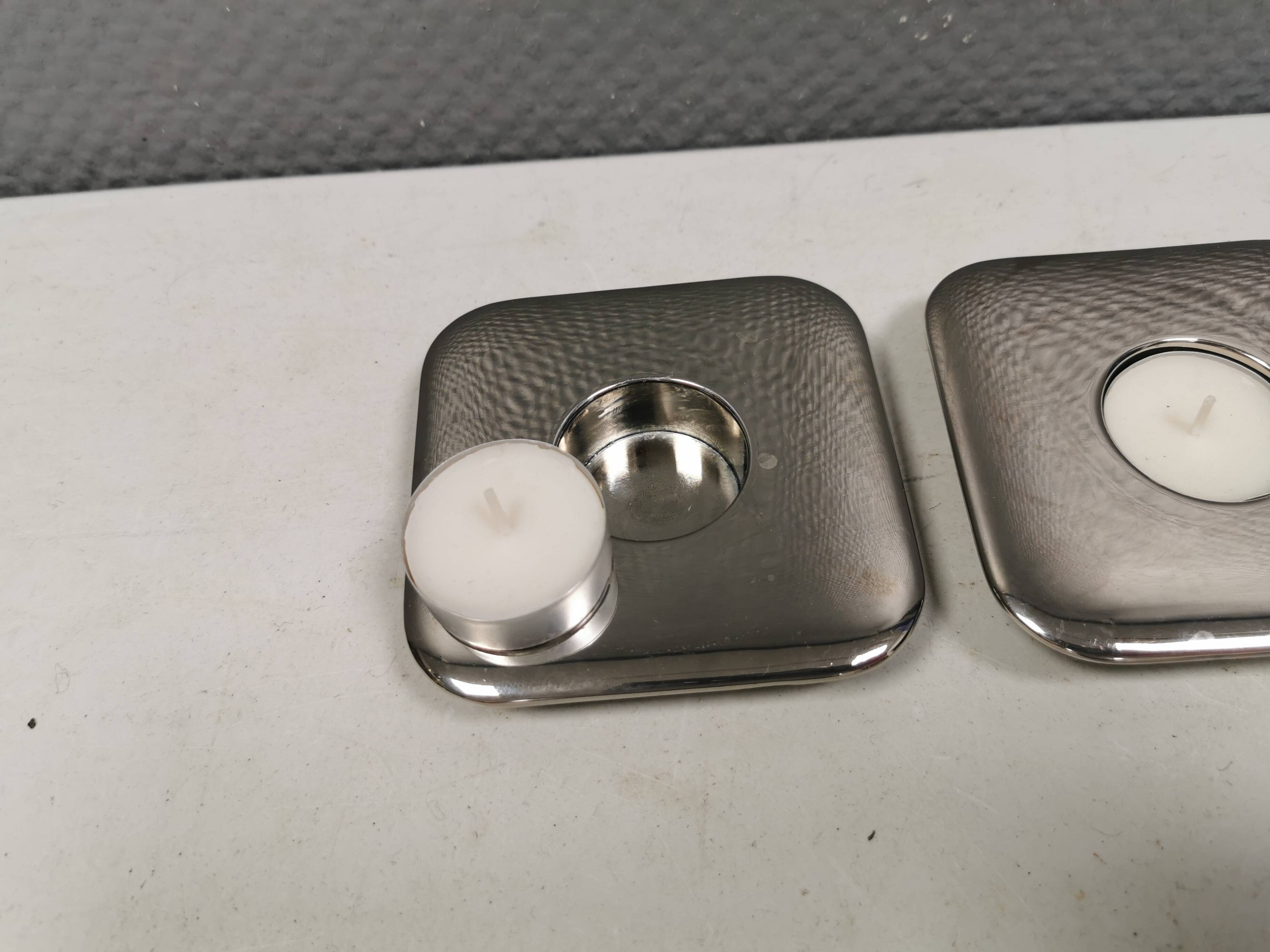 A set of classic Danish candlesticks in polished metal.