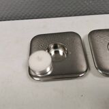 A set of classic Danish candlesticks in polished metal.