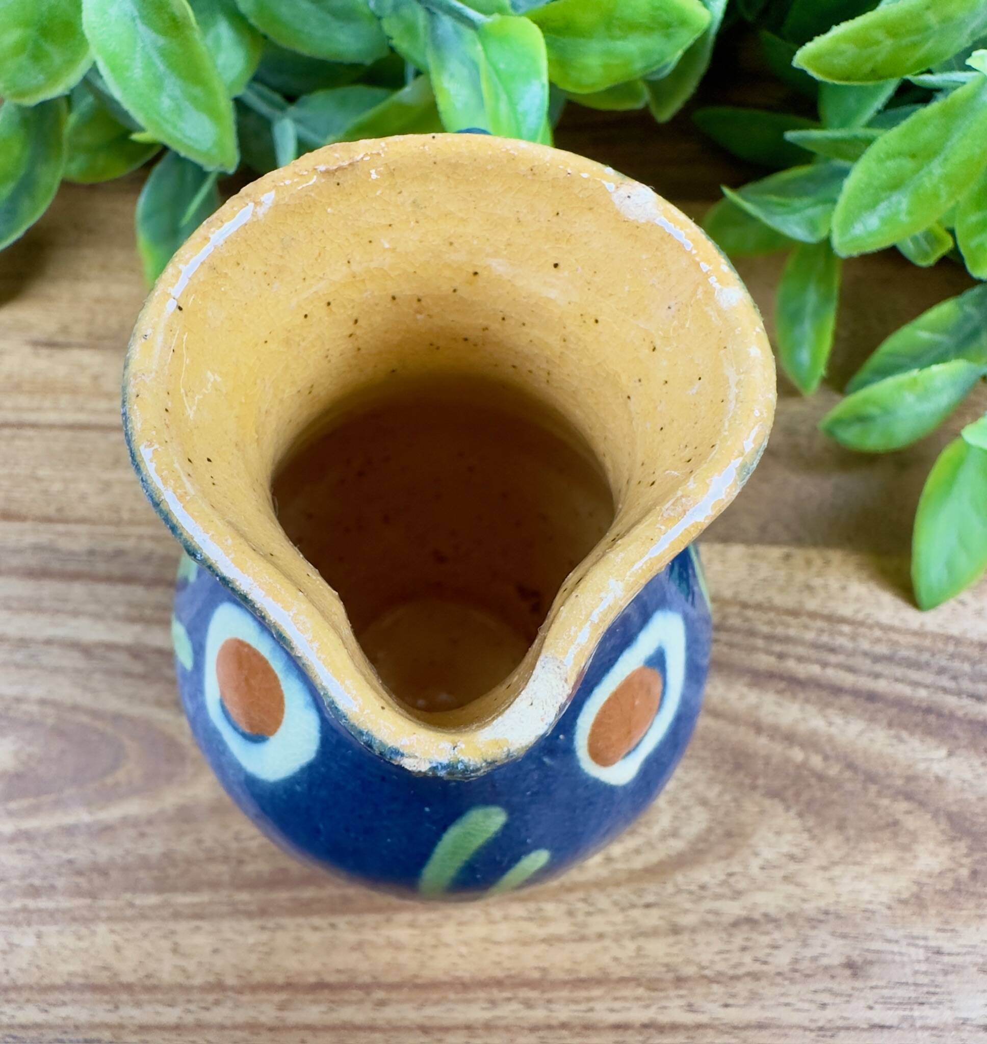 Small blue ceramic jug with hand-painted floral decoration, vintage.
