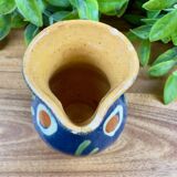 Small blue ceramic jug with hand-painted floral decoration, vintage.