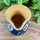 Small blue ceramic jug with hand-painted floral decoration, vintage.