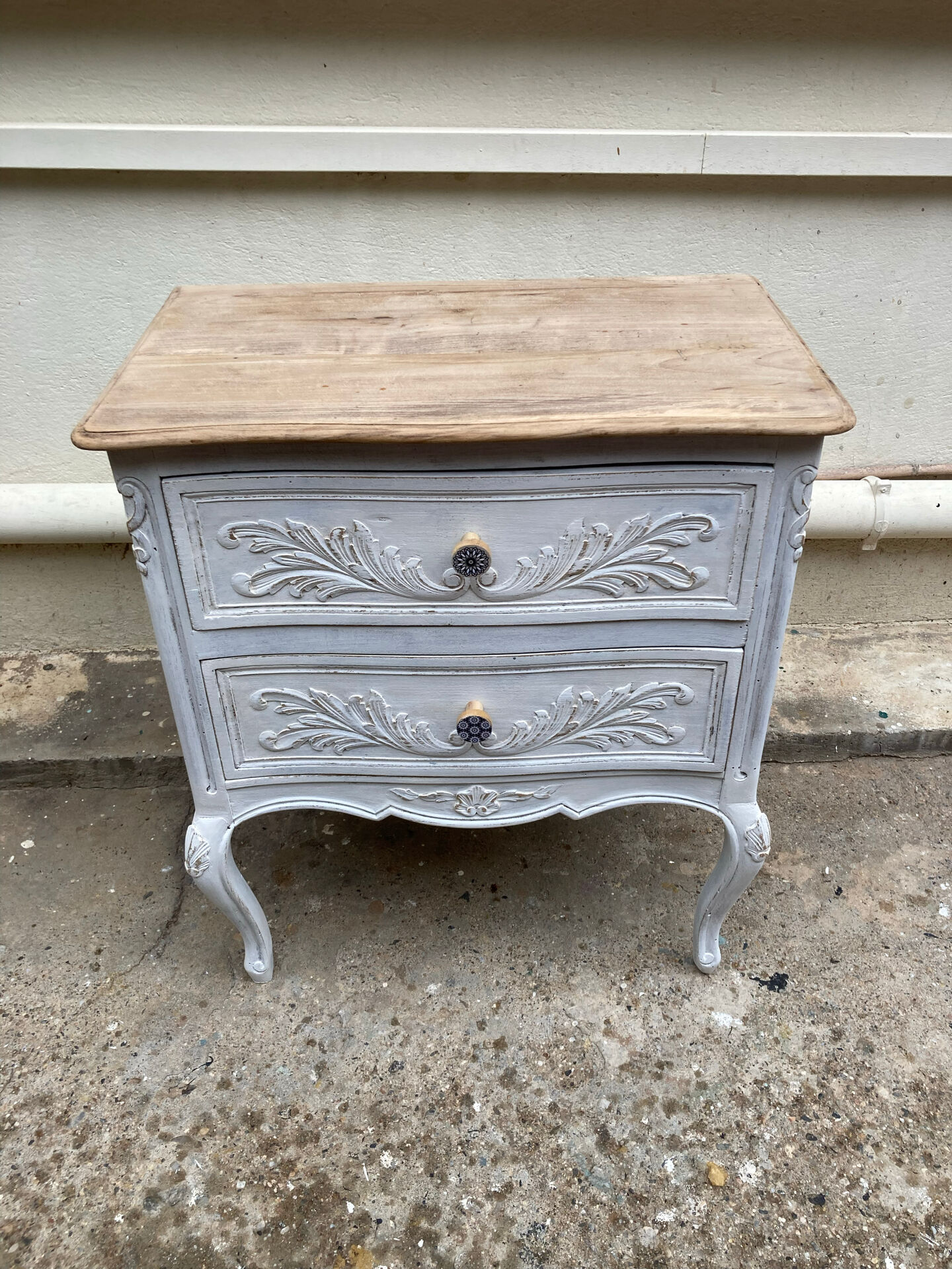 Adorable small chest of drawers or weathered white console.