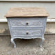 Adorable small chest of drawers or weathered white console.