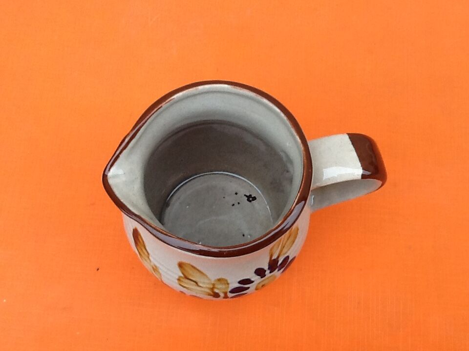 Glazed ceramic pitcher floral decoration