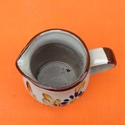 Glazed ceramic pitcher floral decoration