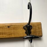 Antique wooden coat rack with metal hooks