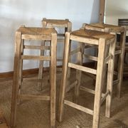 Set of 4 vintage high bar stools in raw solid oak and straw.