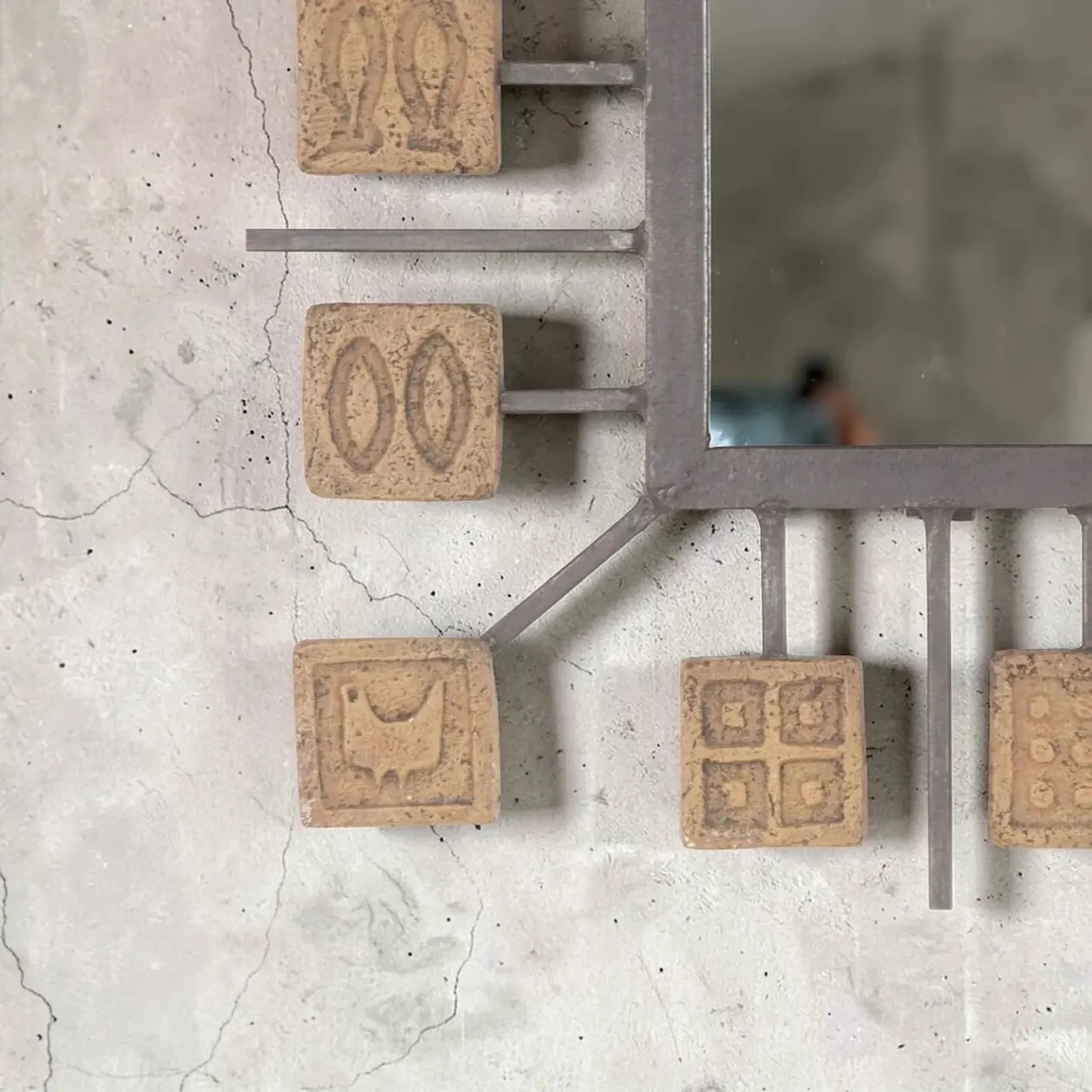 Rectangular brutalist mirror in wrought iron and terracotta tiles.