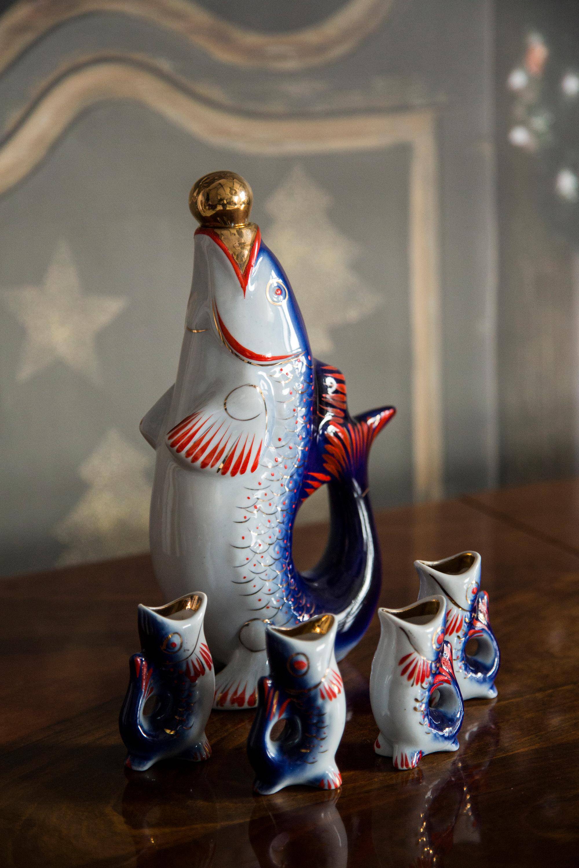 Set of 7 glasses and a glass carafe decorated with blue fish, Mid-Century Modern style, Europe, 1960s.