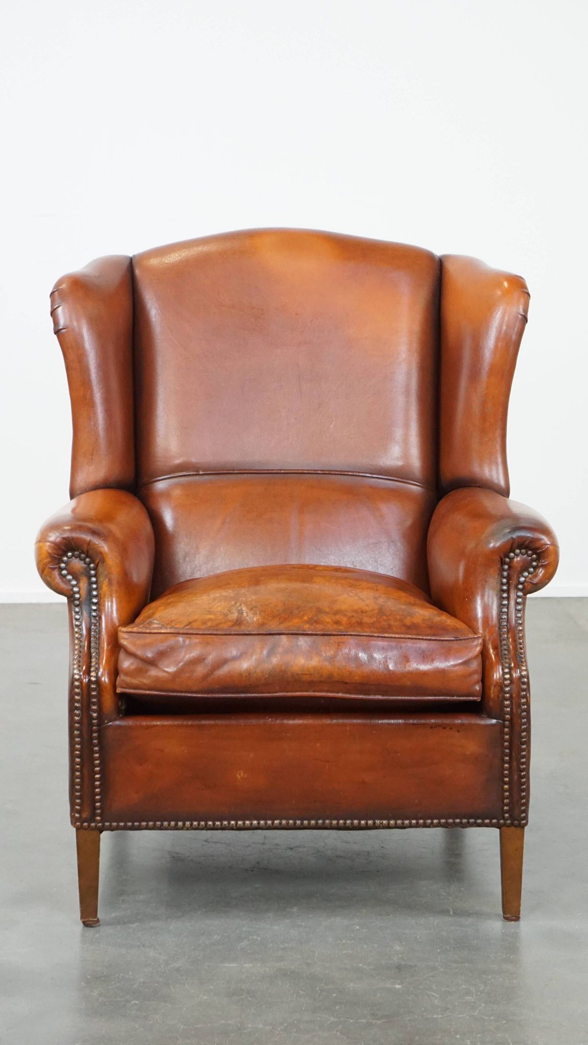 Sheepskin leather wingback chair with patina