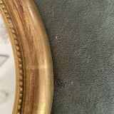 Oval mirror in gilded wood.