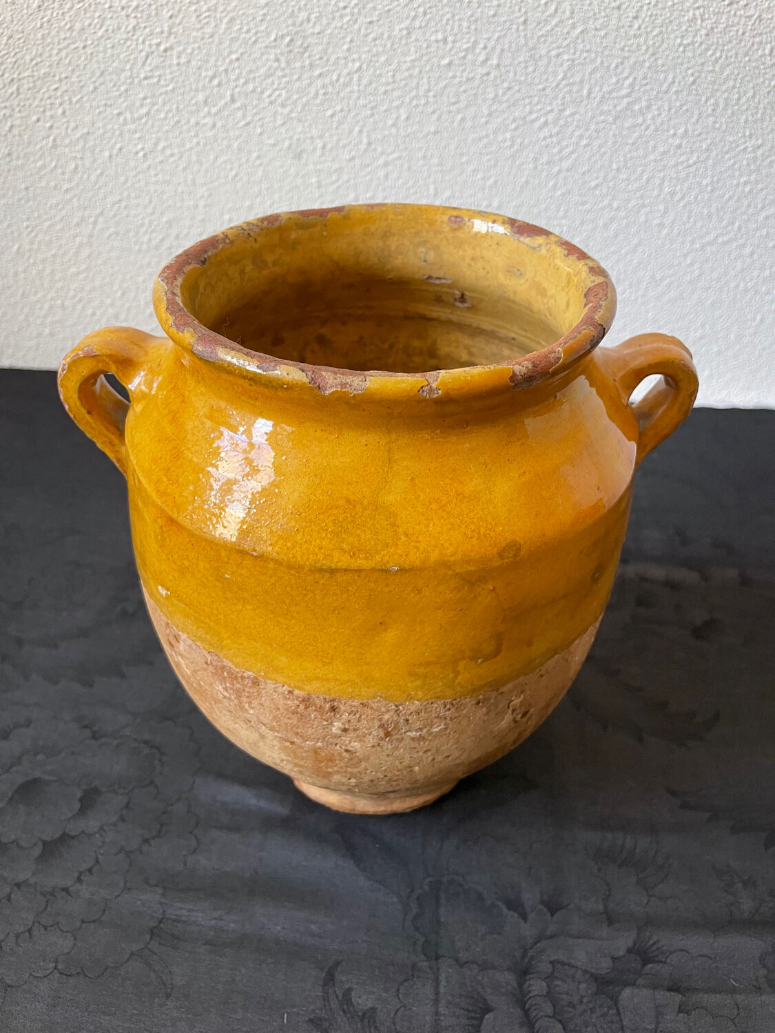 Old candied pot in yellow glazed terracotta