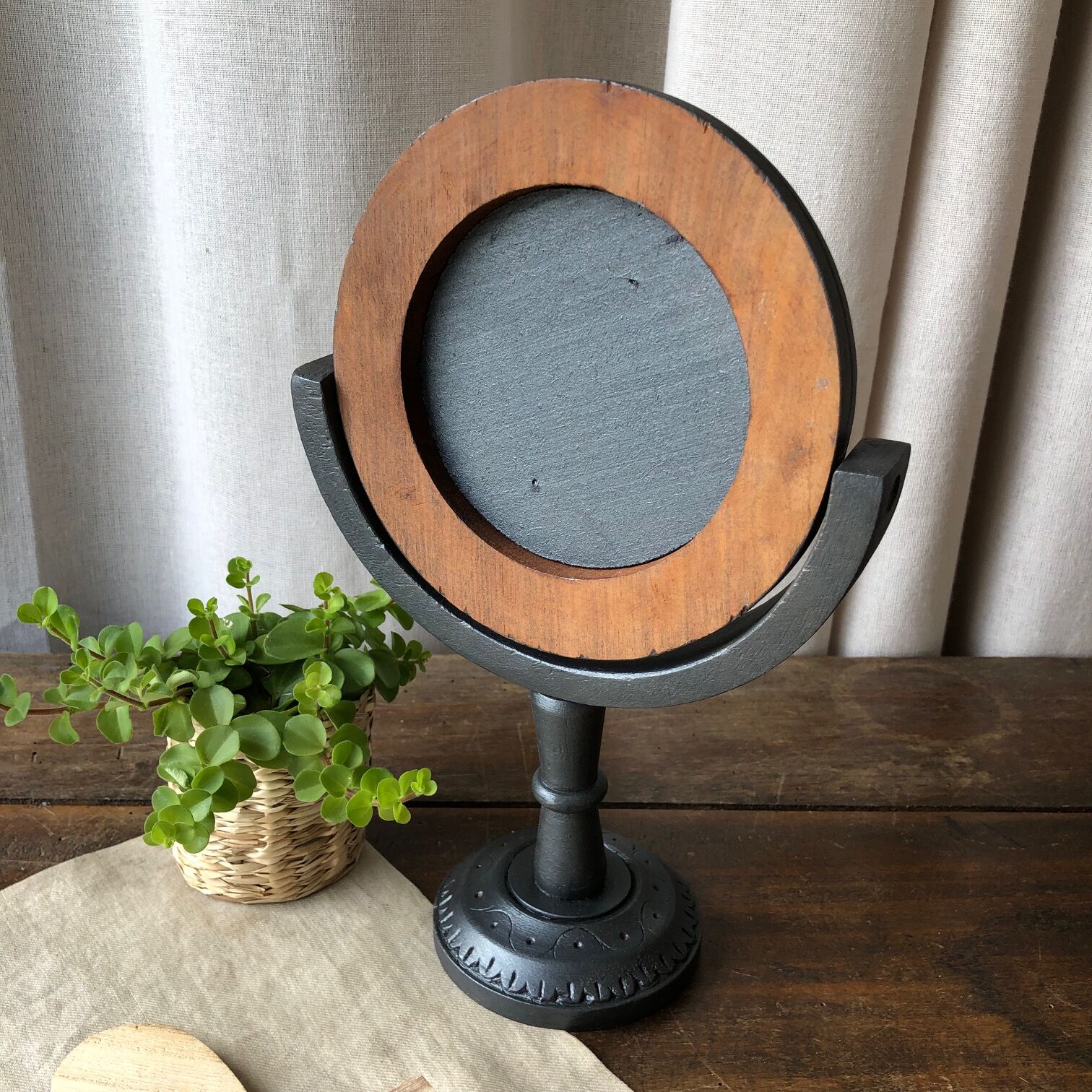 Wooden mirror on foot